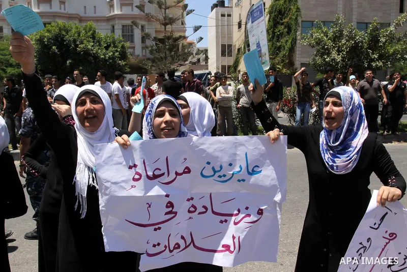 Palestinian students take a part in a protest in front of the headquarters of the Ministry of Education after the end of exams and they object to the difficulty of the exams in Gaza city on July 4, 2011. Photo by Mohamme...