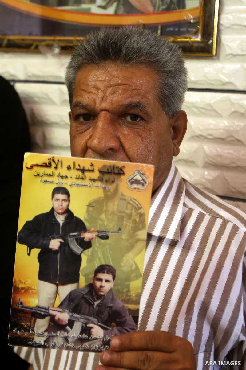 Father of the Palestinian Nabil Masoud, who killed during a military attack in Israel, holds his picture at his home in Gaza city on July 4,2011 .The Palestinian Authority and Israel agreed that 84 bodies of Palestinians...