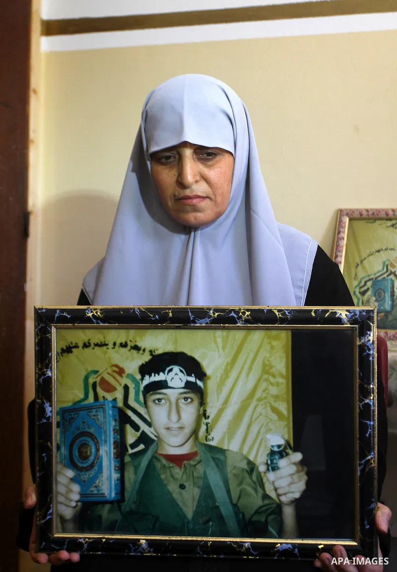 Mother of the Palestinian Hosni Al-Hasi, who killed during a military attack in the former settlement of Doghit, holds his picture at her home in Gaza city on July 4,2011 .The Palestinian Authority and Israel agreed that...