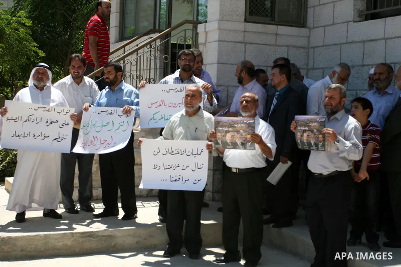 Palestinian Hamas legislators take part in a protest in front of the Red Cross compound in the West Bank city of Ramallah on July 4, 2011 in support with Jerusalem's parliament members who have been living inside the ICR...