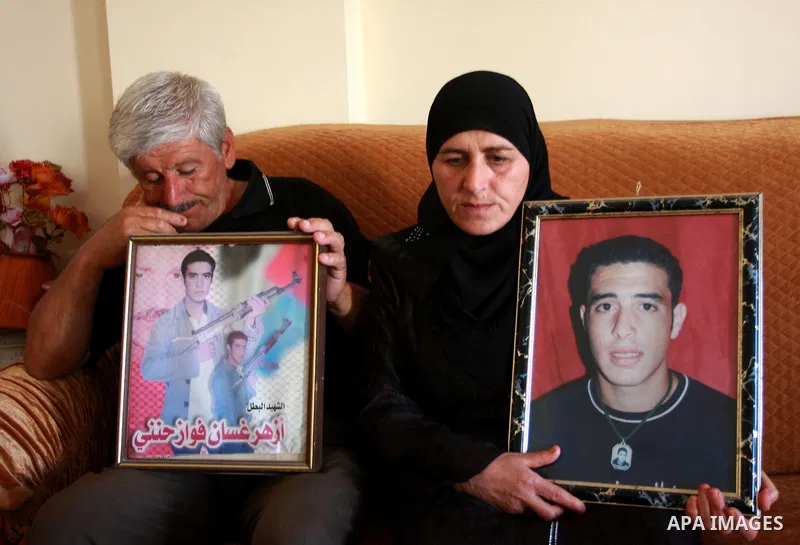 Palestinian relatives of Azhar Abu heet hold his picture on July 4, 2011, in the West Bank town of Nablus, after Palestinian minister for civil affairs Hussein al-Sheikh announced that Israel is to release the bodies of...