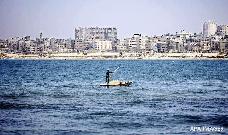 A Palestinian fisherman works on his boat in the port of Gaza City, Tuesday, July 5, 2011, as pro-Palestinian activists from an international flotilla banned from setting sail for Gaza by Greek authorities occupied the S...