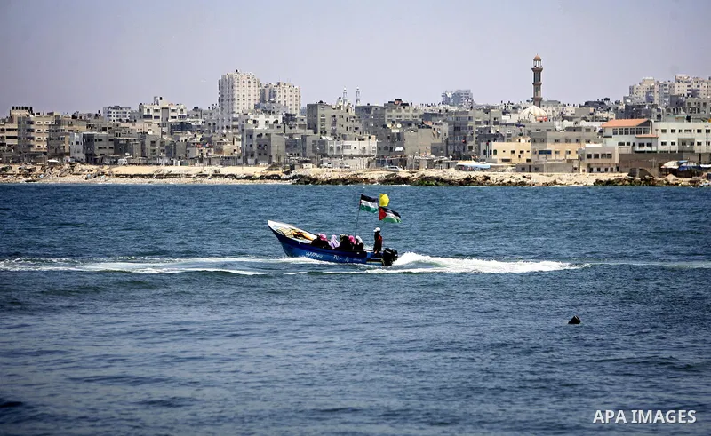 A Palestinian fisherman works on his boat in the port of Gaza City, Tuesday, July 5, 2011, as pro-Palestinian activists from an international flotilla banned from setting sail for Gaza by Greek authorities occupied the S...