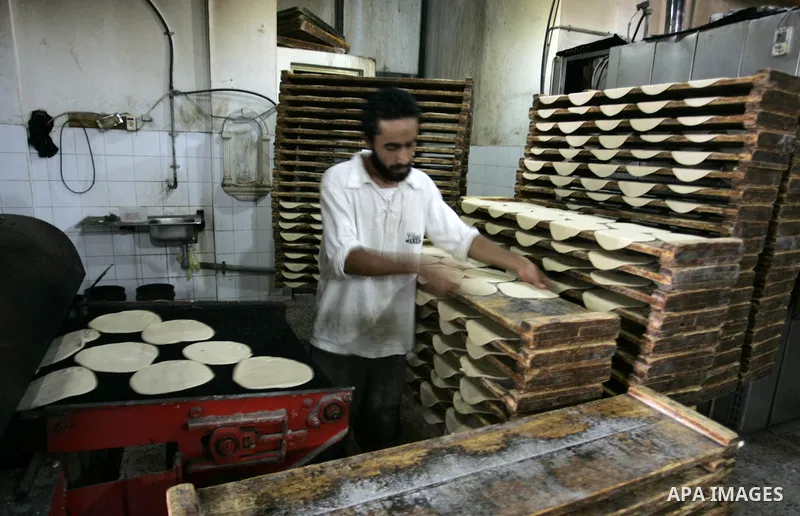 A Palestinian baker prepares bread at his bakery in Rafah, southern Gaza Strip on July 5,2011. Photo by Abed Rahim Khatib