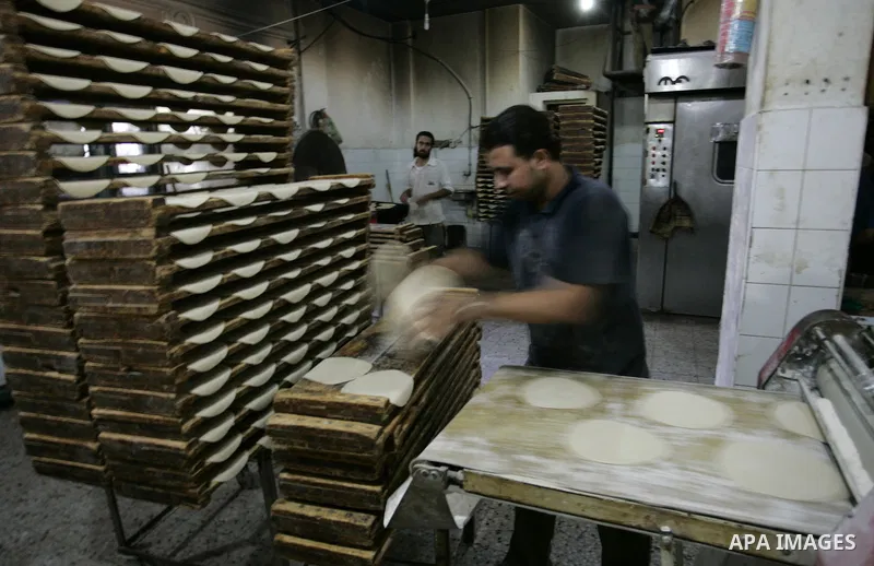 A Palestinian baker prepares bread at his bakery in Rafah, southern Gaza Strip on July 5,2011. Photo by Abed Rahim Khatib