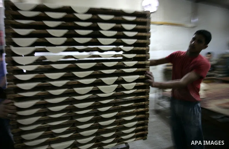 A Palestinian baker prepares bread at his bakery in Rafah, southern Gaza Strip on July 5,2011. Photo by Abed Rahim Khatib