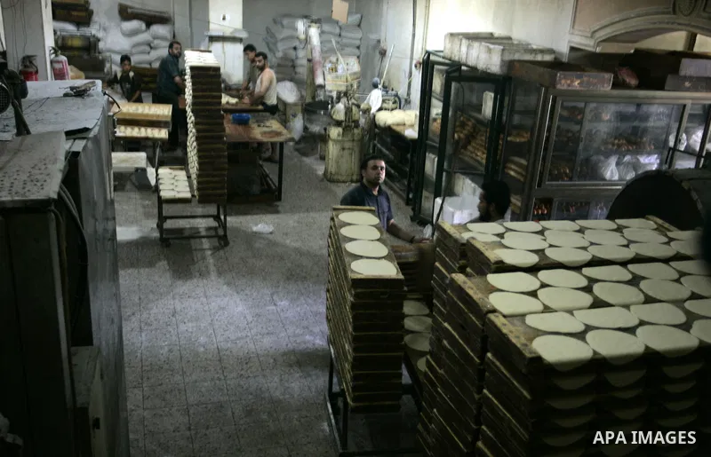 A Palestinian baker prepares bread at his bakery in Rafah, southern Gaza Strip on July 5,2011. Photo by Abed Rahim Khatib