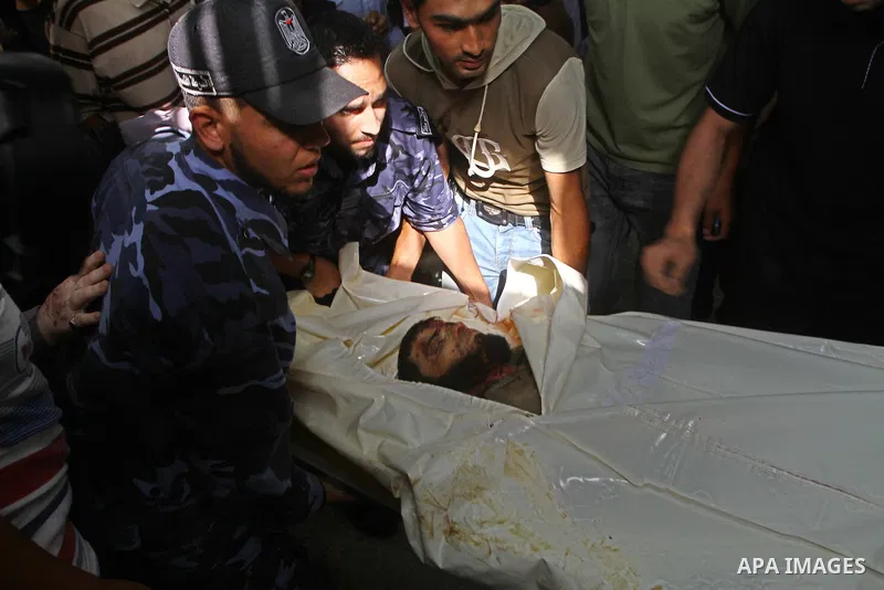 Hamas security officers wheel the bodies of two Palestinians killed by Israeli forces, at the morgue of Al-Aqsa hospital in Deir Al Balah, central Gaza Strip, Tuesday, July 5, 2011. An Israeli attack struck a target alon...