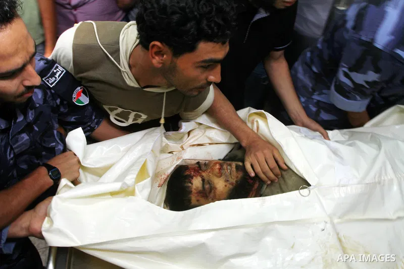 Hamas security officers wheel the bodies of two Palestinians killed by Israeli forces, at the morgue of Al-Aqsa hospital in Deir Al Balah, central Gaza Strip, Tuesday, July 5, 2011. An Israeli attack struck a target alon...