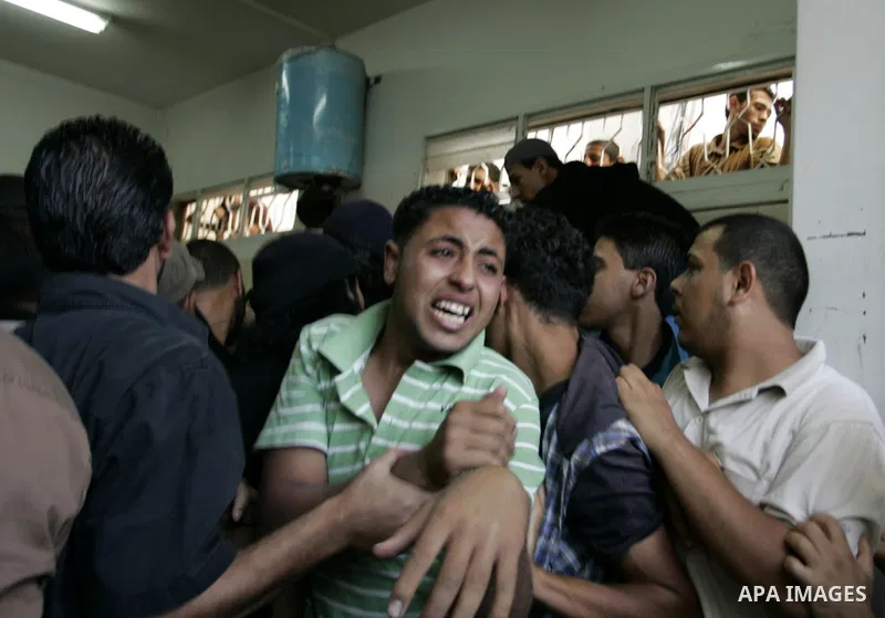 Relatives of two Palestinians killed by Israeli forces react as they arrive at the morgue of Al-Najjar hospital in Rafah, southern Gaza Strip, Tuesday, July 5, 2011. An Israeli attack struck a target along the Gaza Strip...