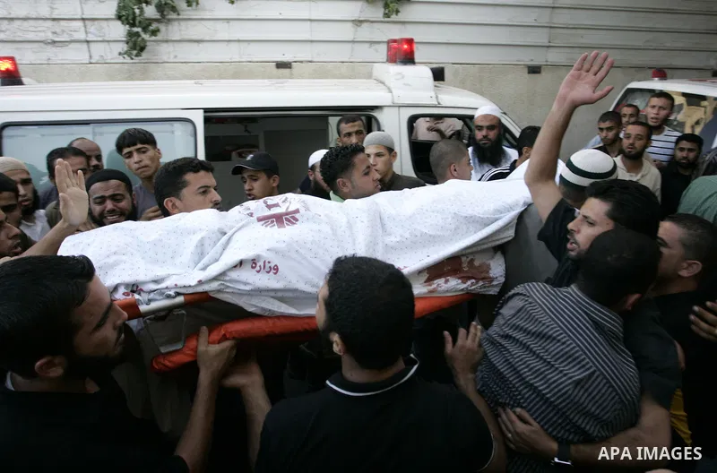 Relatives of two Palestinians killed by Israeli forces react as they arrive at the morgue of Al-Najjar hospital in Rafah, southern Gaza Strip, Tuesday, July 5, 2011. An Israeli attack struck a target along the Gaza Strip...