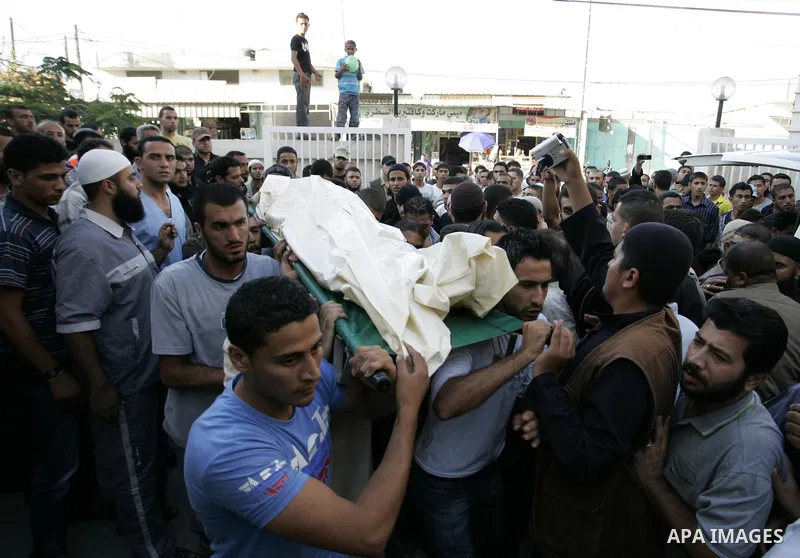 Relatives of two Palestinians killed by Israeli forces react as they arrive at the morgue of Al-Najjar hospital in Rafah, southern Gaza Strip, Tuesday, July 5, 2011. An Israeli attack struck a target along the Gaza Strip...