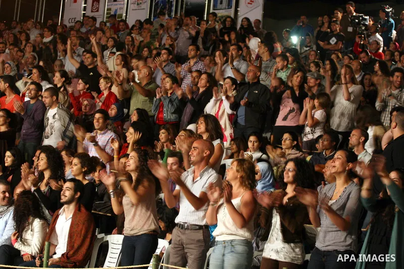 Palestinians attend a concert for Souad Massi, an Algerian singer and songwriter living in France, performs during the Palestine International Festival 2011, in the West Bank city of Ramallah, Tuesday, July 5, 2011. The...
