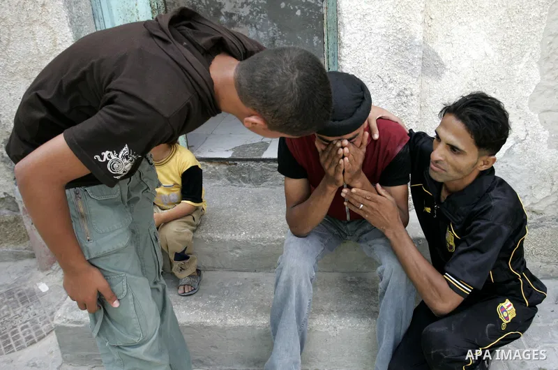 Palestinian relatives of Mohammed Said Abu Jazar, 28-years-old, mourn during his funeral in the Rafah refugee camp, in the southern of Gaza Strip, on July 6, 2011, after being killed along with Kamal Hamdan Muammar overn...