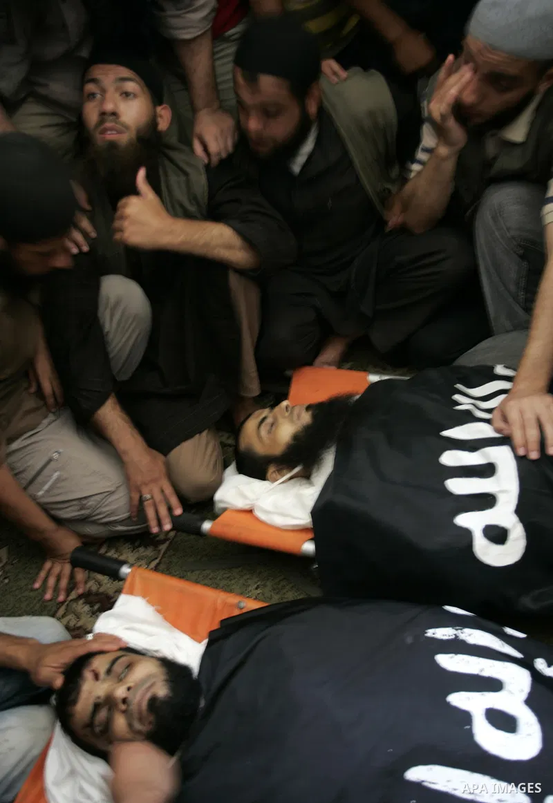 Palestinian relatives and friends of Kamal Hamdan Muammar and Mohammed Said Abu Jazar, both 28-years-old, ready to bury them following prayers at the mosque in the Rafah refugee camp, in the southern of Gaza Strip, on Ju...
