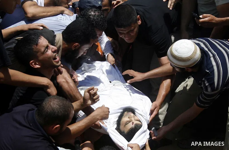 Palestinian relatives carry the body of Kamal Hamdan Muammar, 28-years-old, for burial following prayers at the mosque in the Rafah refugee camp, in the southern of Gaza Strip, on July 6, 2011, after being killed along w...