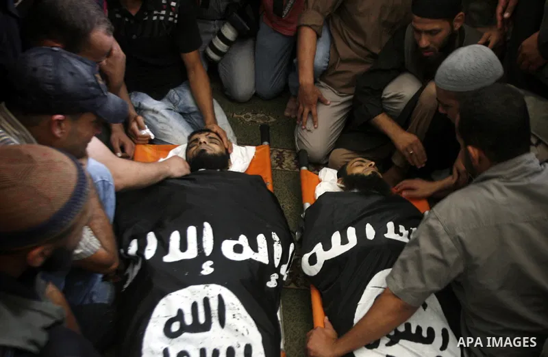 Palestinian relatives and friends of Kamal Hamdan Muammar and Mohammed Said Abu Jazar, both 28-years-old, ready to bury them following prayers at the mosque in the Rafah refugee camp, in the southern of Gaza Strip, on Ju...