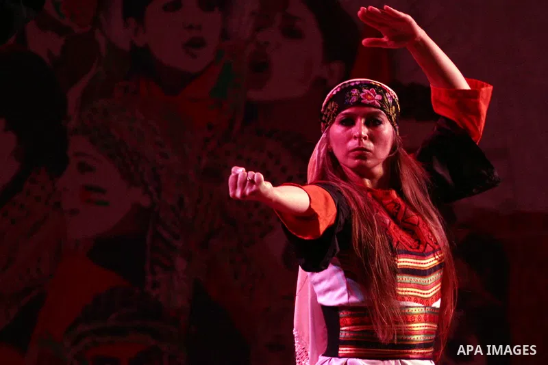 Dancers of the El-Funoun Palestinian Popular Dance Troupe perform on the third day of the 13th Palestine International Festival in the West Bank city of Ramallah on July 6, 2011. The festival, which features music and da...