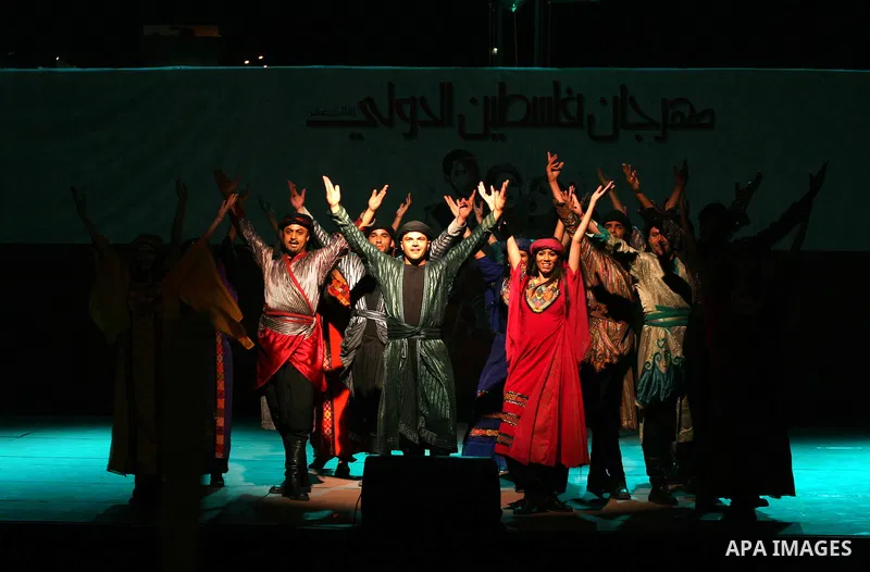 Dancers of the El-Funoun Palestinian Popular Dance Troupe perform on the third day of the 13th Palestine International Festival in the West Bank city of Ramallah on July 6, 2011. The festival, which features music and da...