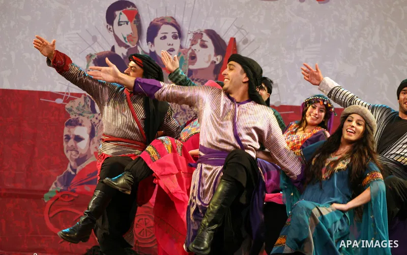 Dancers of the El-Funoun Palestinian Popular Dance Troupe perform on the third day of the 13th Palestine International Festival in the West Bank city of Ramallah on July 6, 2011. The festival, which features music and da...