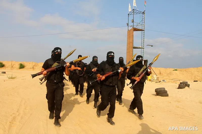 Palestinian militants of al-Ansar brigades, the military wing of al-Ahrar movement, take part in a military parade in Khan Younis in the southern Gaza Strip on July 7, 2011, to mark the fifth anniversary of their group's...