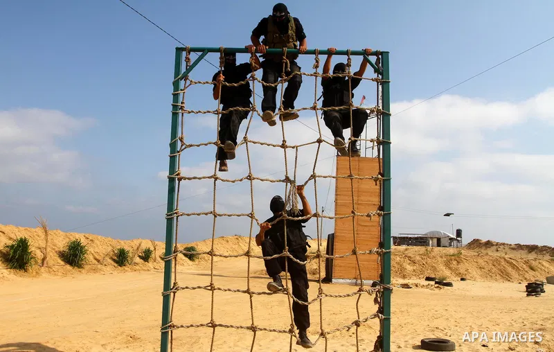 Palestinian militants from Al-Ansar brigades, the armed wing of Al-Ahrar movement, demonstrate their skills during a drill in front of the media in Khan Younis in the southern Gaza Strip July 7, 2011. Photo by Ashraf Amr...