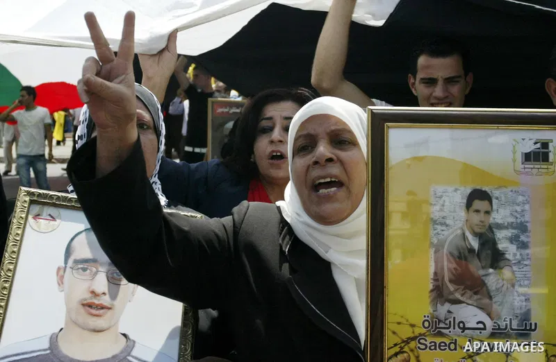 Palestinian women hold pictures of their relatives, held in Israeli jails, during a protest calling for their release in the West Bank city of Nablus, Thursday, July 7, 2011. Israel currently holds about 5,600 Palestinia...