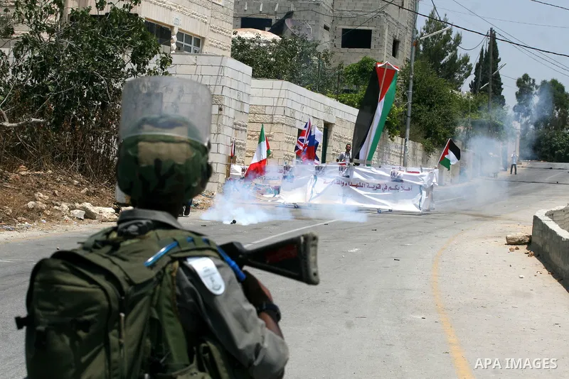 Israeli soldiers clash with Palestinian protesters from the West Bank village of Nabi Saleh, north of Ramallah, on July 8, 2011, during the weekly Friday protest against Israeli West Bank settlement expansion. Photo by I...