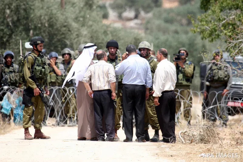 Israeli soldiers take positions as Palestinians protest in the village of Kufr Qaddum near the Israeli settlement of Kdumim, in the northern West Bank Friday, July 8, 2011. The protest concerned Palestinian access to lan...
