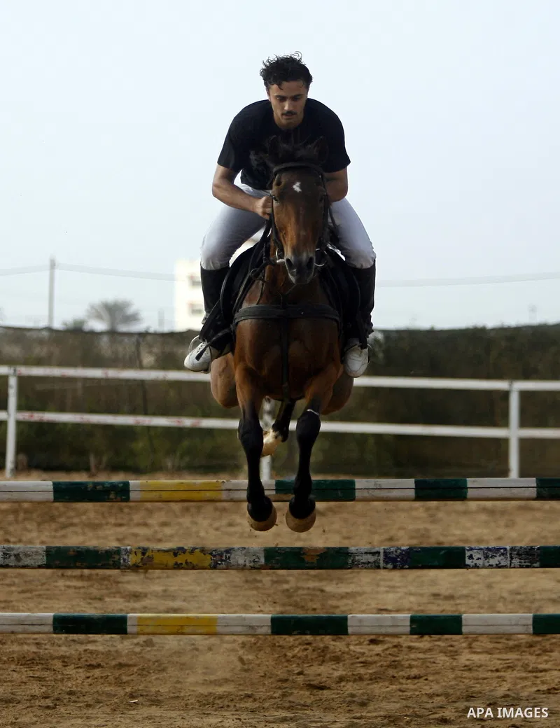 A Palestinian rides a horse during the "Jump Championship" race in Gaza City July 8, 2011. Photo by Ali Jadallah