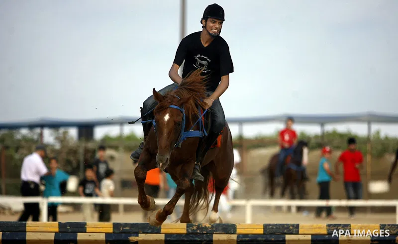 A Palestinian rides a horse during the "Jump Championship" race in Gaza City July 8, 2011. Photo by Ali Jadallah