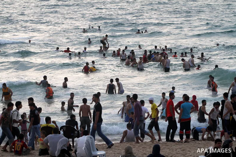 Palestinians enjoy swimming in the sea on Gaza's beach on on July 8, 2011. Reports state that during the summer the beach is a major venue for entertainment and leisure in the Gaza. Photo by Mohammed Asad