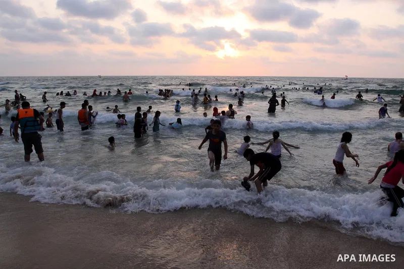 Palestinians enjoy swimming in the sea on Gaza's beach on on July 8, 2011. Reports state that during the summer the beach is a major venue for entertainment and leisure in the Gaza. Photo by Mohammed Asad