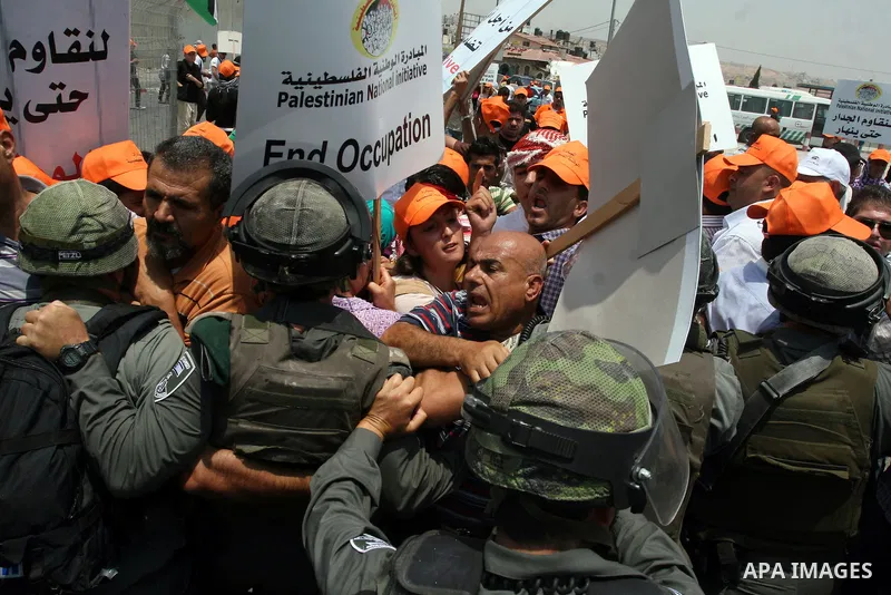 Israeli security forces push back locally-based Palestinian demonstrators during clashes at the Qalandia checkpoint between the West Bank city of Ramallah and Jerusalem, Saturday, July 9, 2011. Israel's interior ministry...