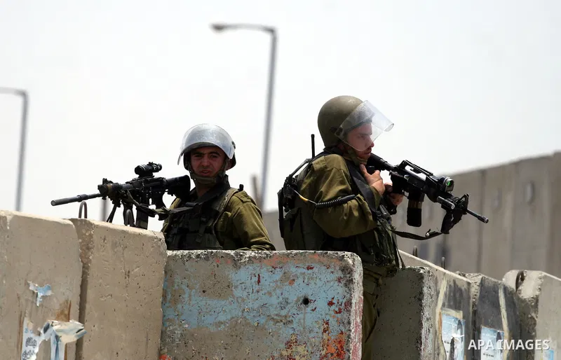 Israeli security forces take position during clashes with locally-based Palestinian demonstrators, not pictured, at the Qalandia checkpoint between the West Bank city of Ramallah and Jerusalem, Saturday, July 9, 2011. Is...