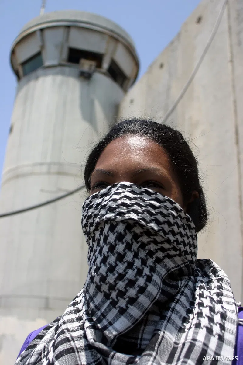 Palestinians and foreigners protest in front of a section of Israel's controversial separation barrier at the main entrance of the West Bank city of Bethlehem on July 10, 2011, marking the seventh anniversary of a ruling...