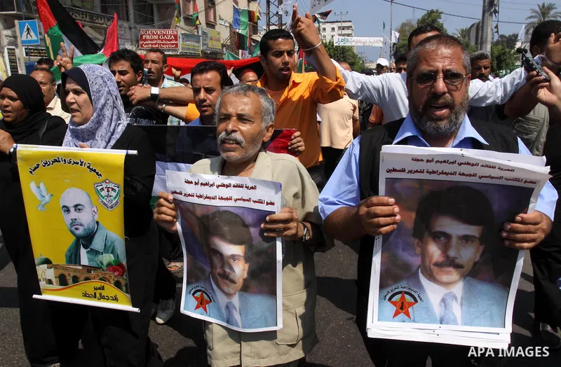 Relatives of Palestinian prisoners attend a march organized by the Red Cross calling Israel to allow residents of Gaza to visit their relatives imprisoned in Israel, on July 11, 2011 in Gaza City. Israel stopped allowing...