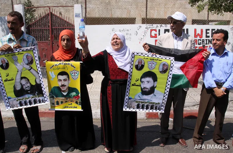 Relatives of Palestinian prisoners attend a march organized by the Red Cross calling Israel to allow residents of Gaza to visit their relatives imprisoned in Israel, on July 11, 2011 in Gaza City. Israel stopped allowing...