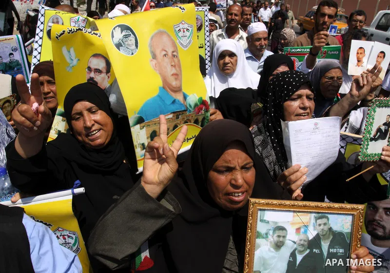 Relatives of Palestinian prisoners attend a march organized by the Red Cross calling Israel to allow residents of Gaza to visit their relatives imprisoned in Israel, on July 11, 2011 in Gaza City. Israel stopped allowing...