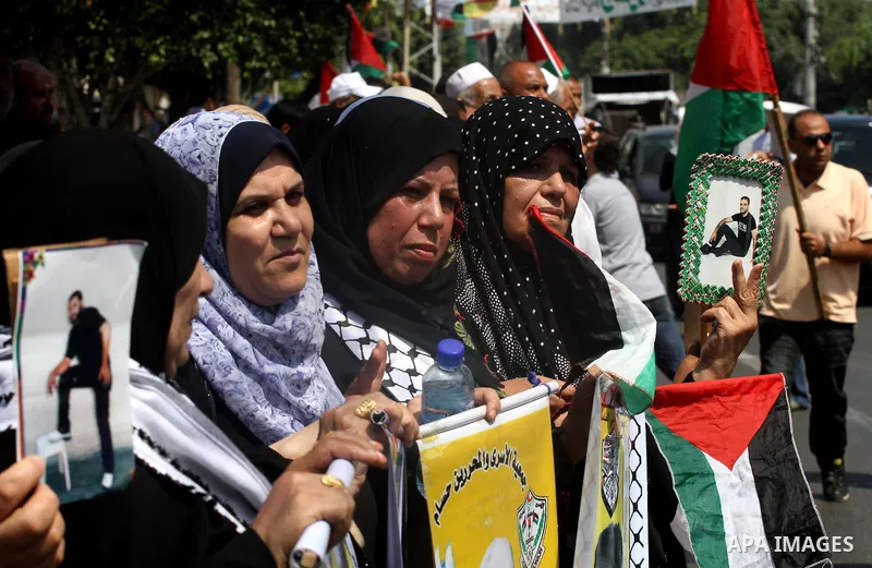Relatives of Palestinian prisoners attend a march organized by the Red Cross calling Israel to allow residents of Gaza to visit their relatives imprisoned in Israel, on July 11, 2011 in Gaza City. Israel stopped allowing...
