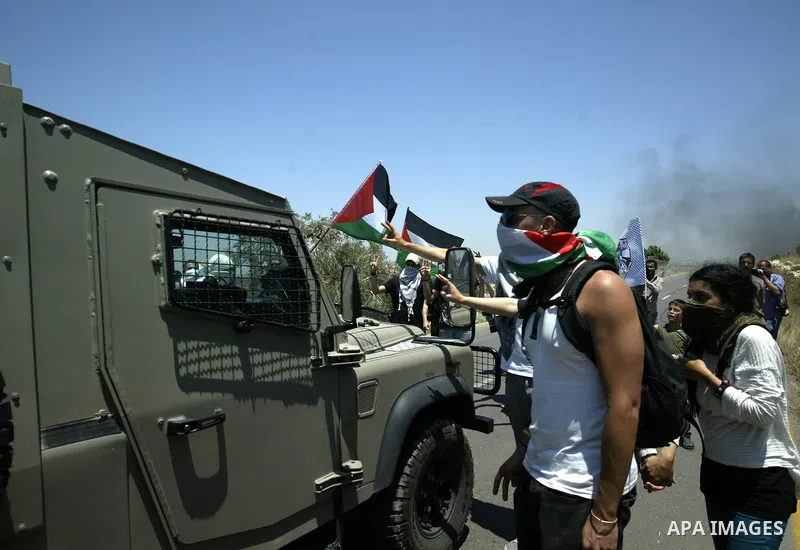Palestinian and foreign protesters demonstrate against Israeli occupation and settlements on July 11, 2011in the village of Ezbet Tabeeb near the West Bank town of Qalqilya. Photo by Wagdi Eshtayah