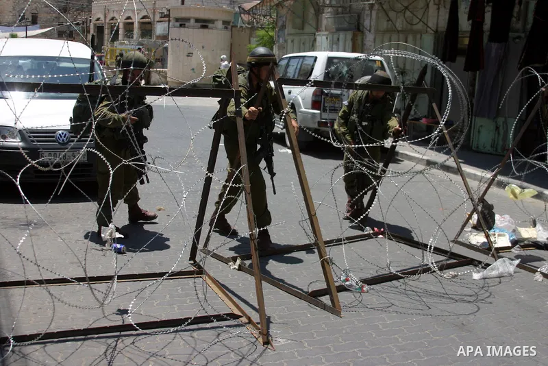 Israeli soldiers stop Palestinian and International activists who attempt to demonstrate against the closure of Shuhada Street in Hebron,a main artery blocked by an Israeli military checkpoint in the center of the West B...