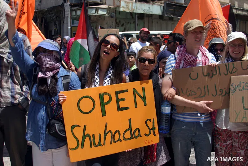 Palestinians and International activists pro-Palestinians demonstrate against the closure of Shuhada Street in Hebron, the main artery blocked by an Israeli military checkpoint in the center of the West Bank town of Hebr...