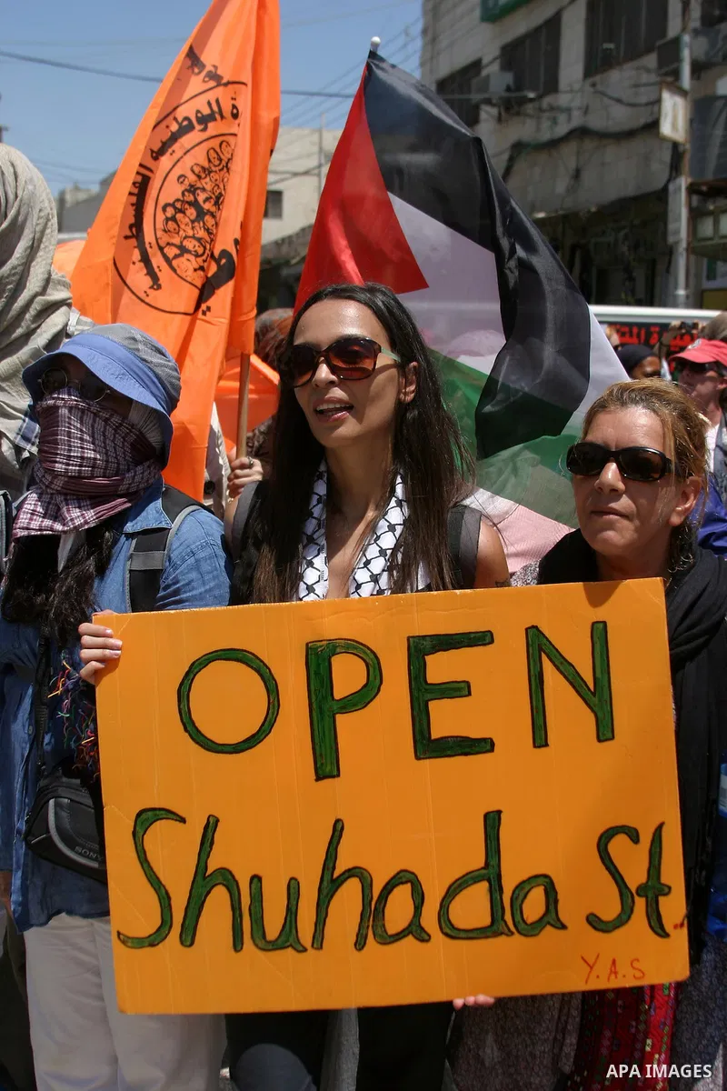 Palestinians and International activists pro-Palestinians demonstrate against the closure of Shuhada Street in Hebron, the main artery blocked by an Israeli military checkpoint in the center of the West Bank town of Hebr...