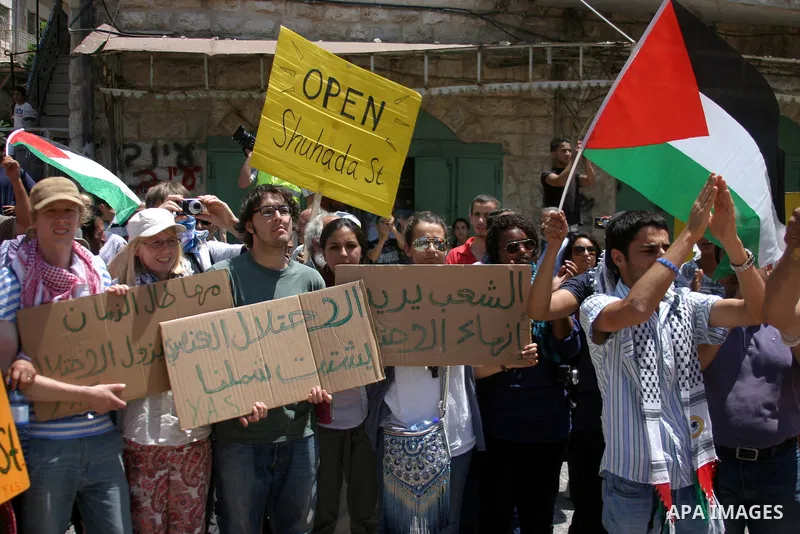 Palestinians and International activists pro-Palestinians demonstrate against the closure of Shuhada Street in Hebron, the main artery blocked by an Israeli military checkpoint in the center of the West Bank town of Hebr...