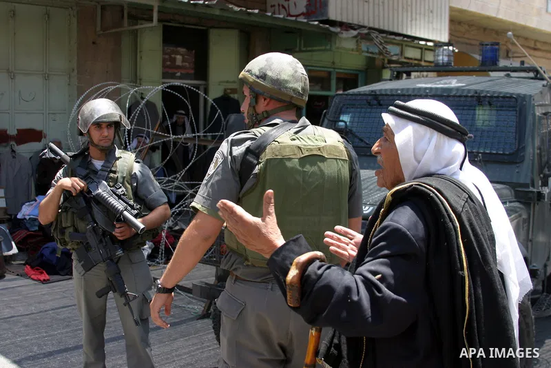 Israeli soldiers stop Palestinian and International activists who attempt to demonstrate against the closure of Shuhada Street in Hebron,a main artery blocked by an Israeli military checkpoint in the center of the West B...