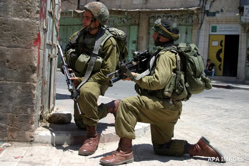 Israeli soldiers stop Palestinian and International activists who attempt to demonstrate against the closure of Shuhada Street in Hebron,a main artery blocked by an Israeli military checkpoint in the center of the West B...