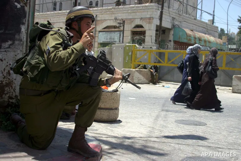 Israeli soldiers stop Palestinian and International activists who attempt to demonstrate against the closure of Shuhada Street in Hebron,a main artery blocked by an Israeli military checkpoint in the center of the West B...