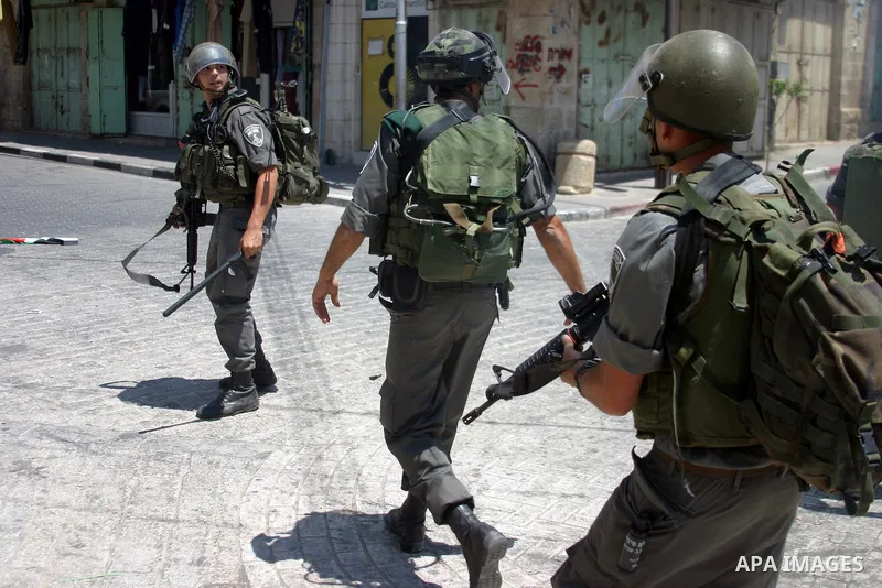 Israeli soldiers stop Palestinian and International activists who attempt to demonstrate against the closure of Shuhada Street in Hebron,a main artery blocked by an Israeli military checkpoint in the center of the West B...