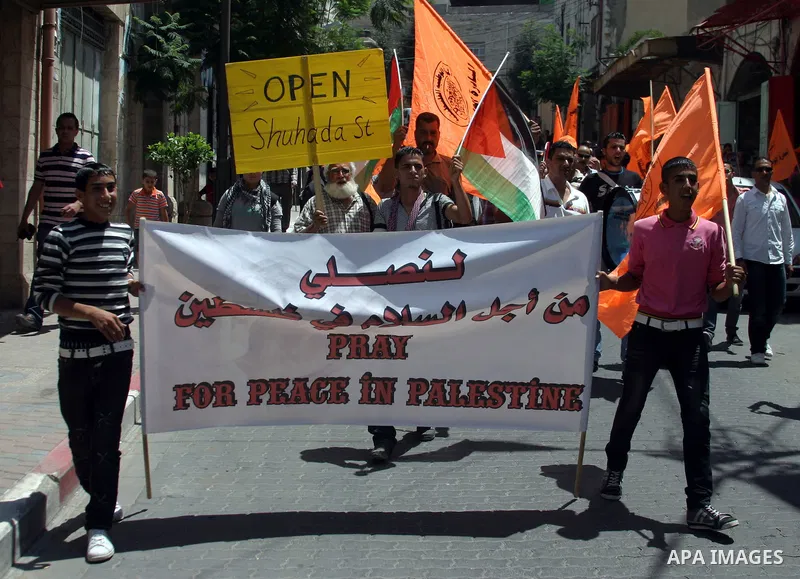 Palestinians and International activists pro-Palestinians demonstrate against the closure of Shuhada Street in Hebron, the main artery blocked by an Israeli military checkpoint in the center of the West Bank town of Hebr...